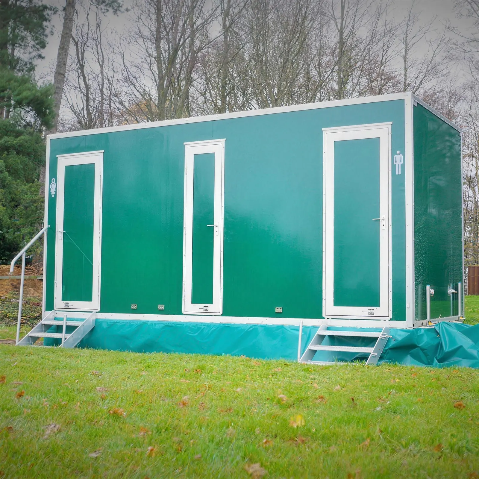 One of our green luxury toilet trailers set up on a lawn